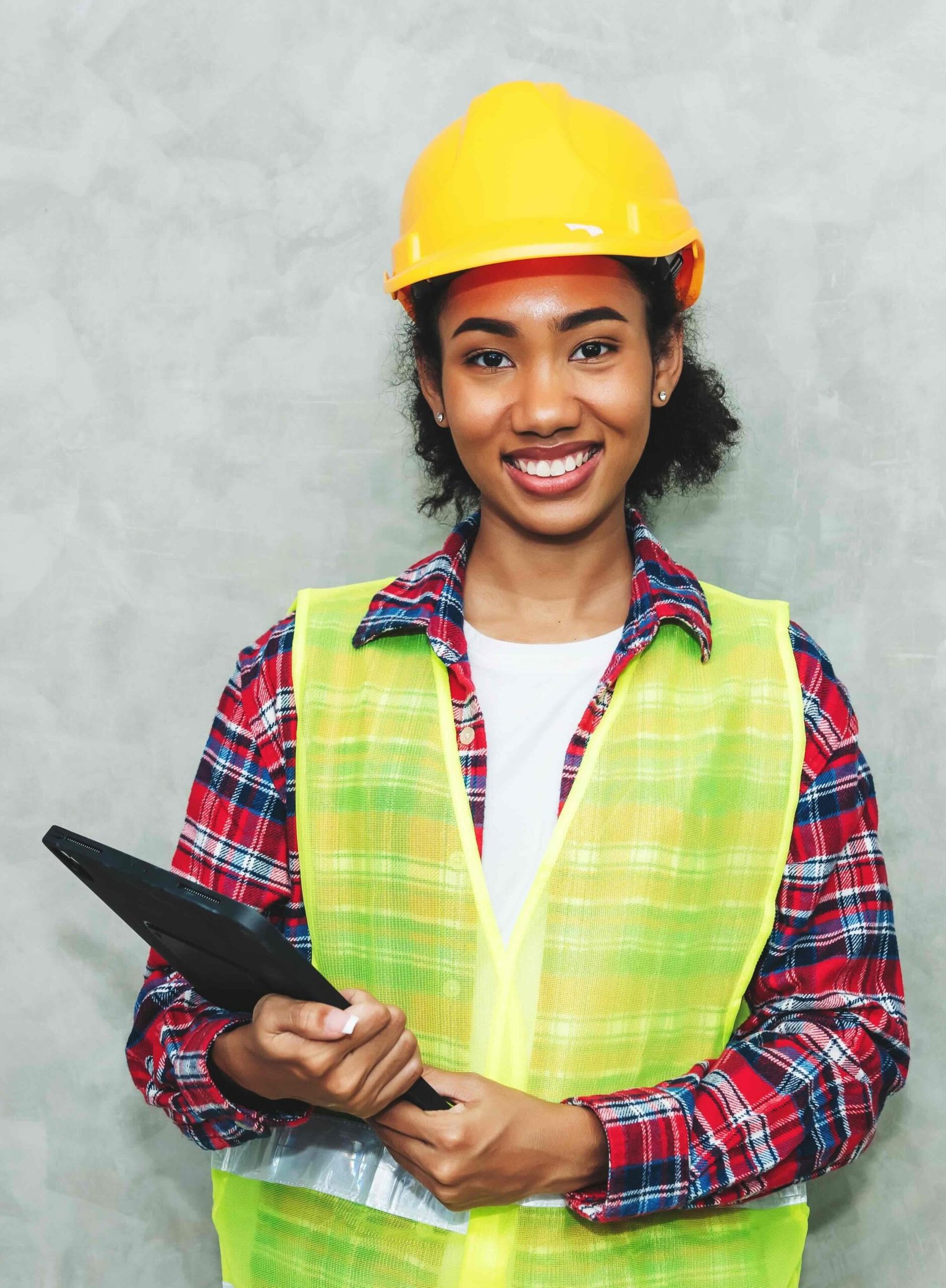 portrait professional young black woman civil engineer architecture worker wearing hard hat safety working construction site warehouseusing laptop work